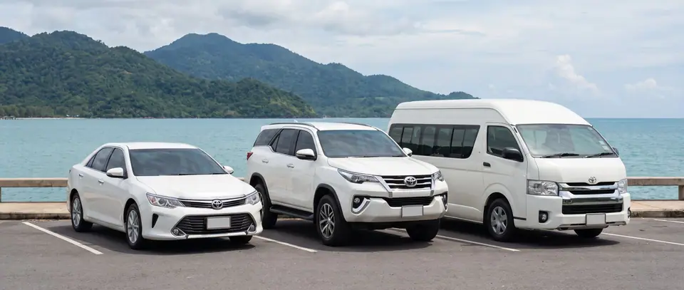 Sedan, SUV and van parked on the Trat coast facing Koh Chang
